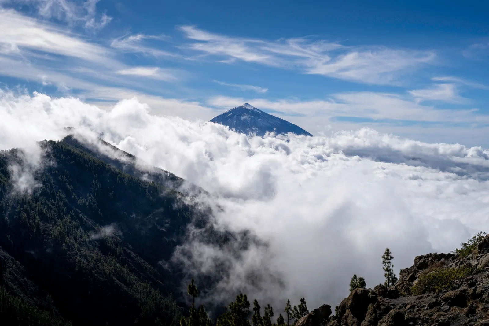 Majestic view of Mount Teide surrounded by clouds in the Canary Islands.