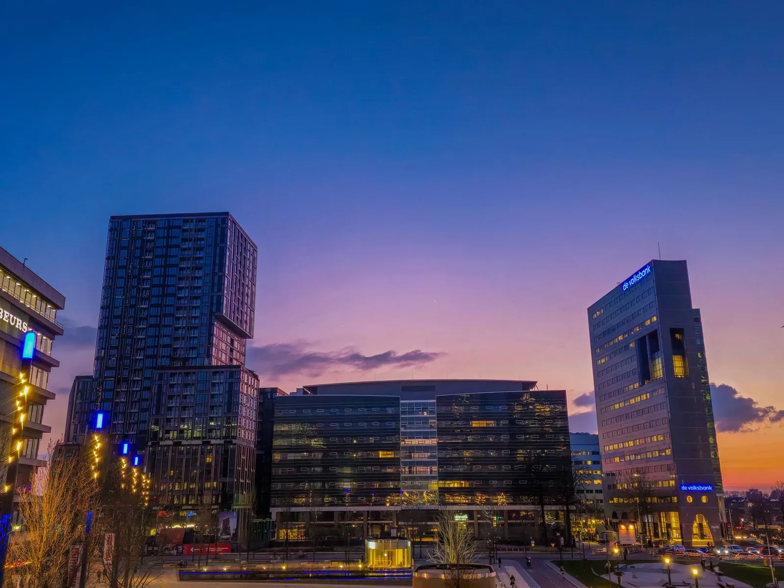 Stunning cityscape of Utrecht with illuminated high-rise buildings at twilight.