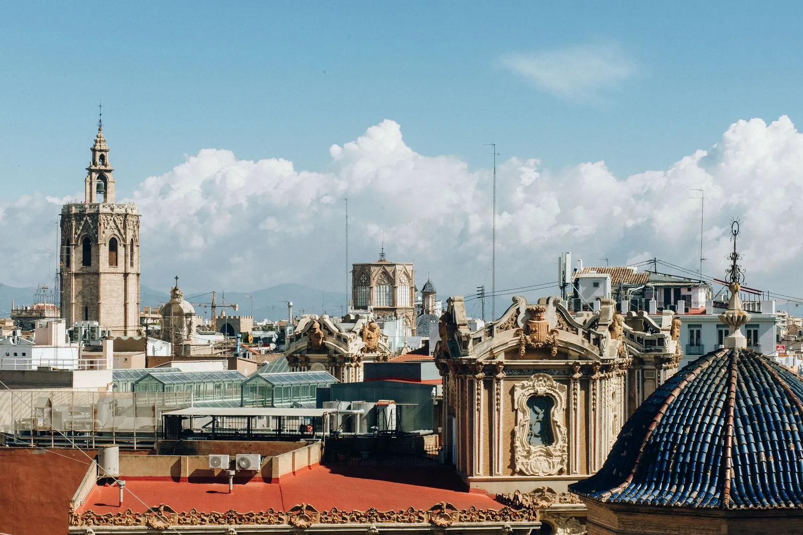 Skyline of Valencia with historic architecture and towers under a bright sky.
