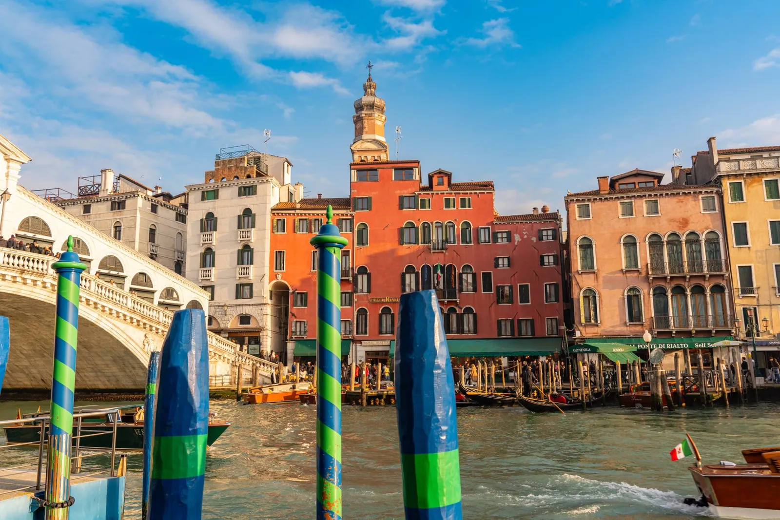 Beautiful view of Rialto Bridge and colorful buildings along the Grand Canal in Venice, Italy.