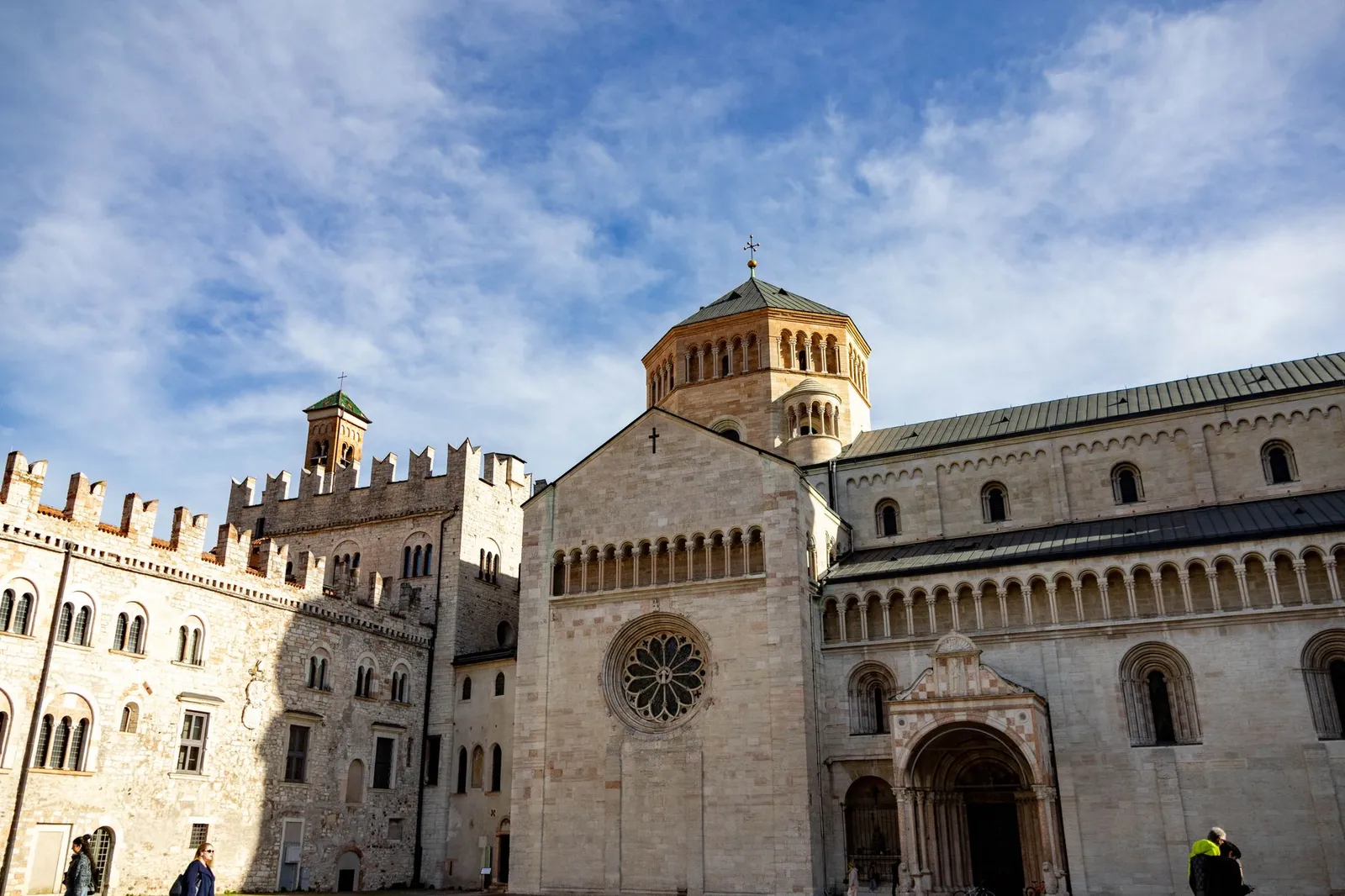 Panoramic view of the iconic Trento Cathedral under a clear blue sky.
