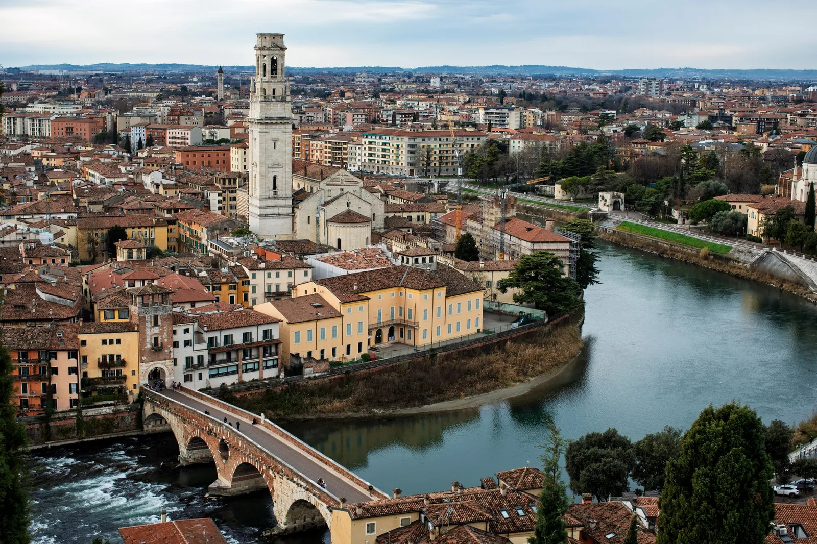 A beautiful aerial view of Verona, Italy featuring the Adige River and historic architecture.