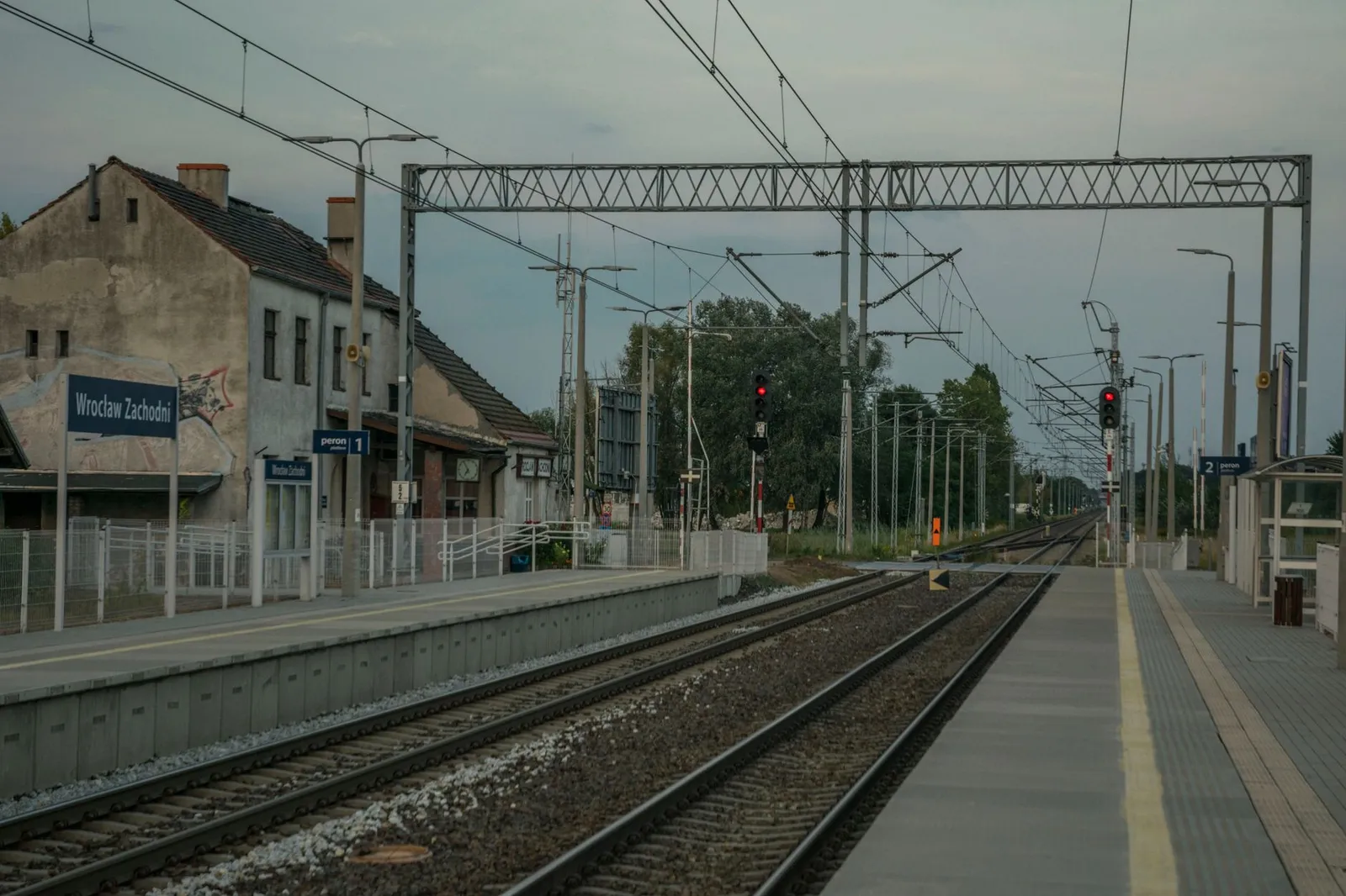 View of Wrocław Zachodni railway station with tracks and platforms on a clear day.