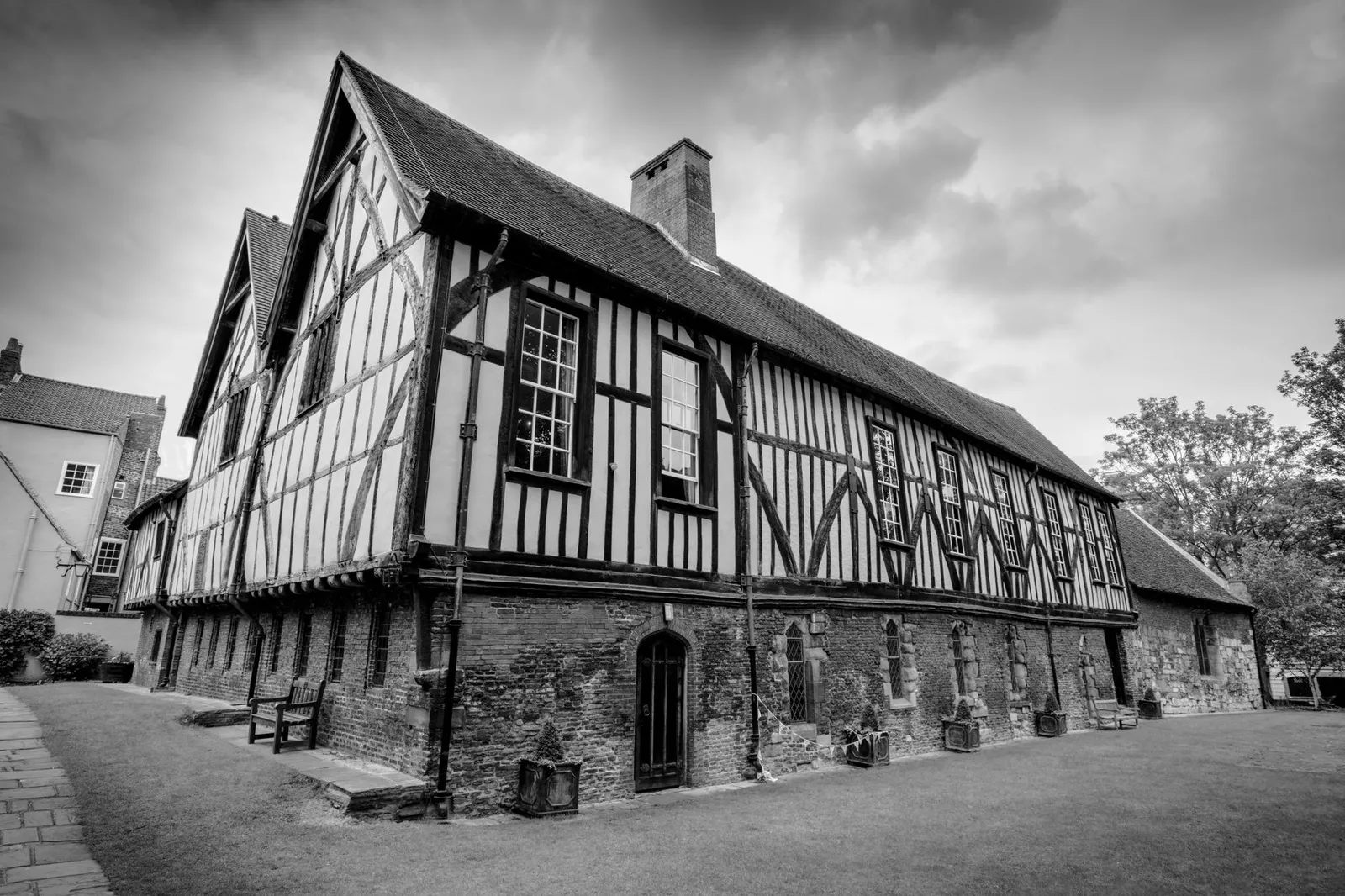 Black and white photo of The Merchant Adventurers' Hall in York, showcasing beautiful historic architecture.
