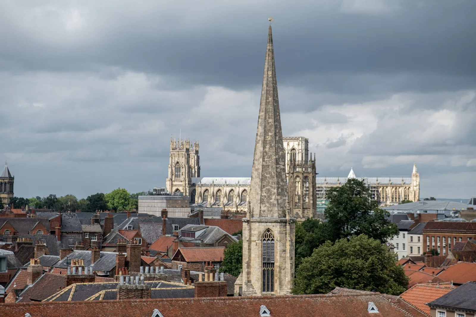 Scenic view of York with prominent cathedral spires under cloudy skies.