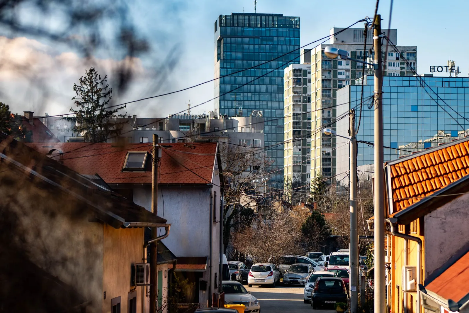 A scenic view of Zagreb showcasing urban buildings and residential houses under a clear sky.