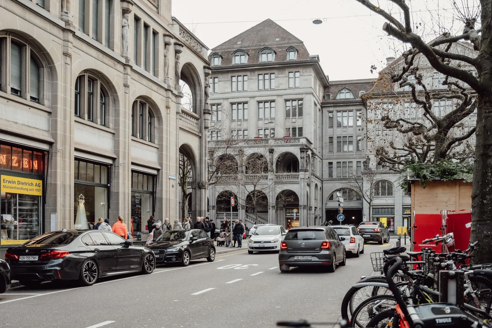 Explore the vibrant street life and historic architecture of Zurich, Switzerland in this captivating photo.